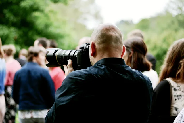 photographer, camera, taking photos, lens, recording, photo shoot, photography, person, man, digital camera, telephoto, telephoto lens, photo. Non-leading customer interviews for video marketing agencies